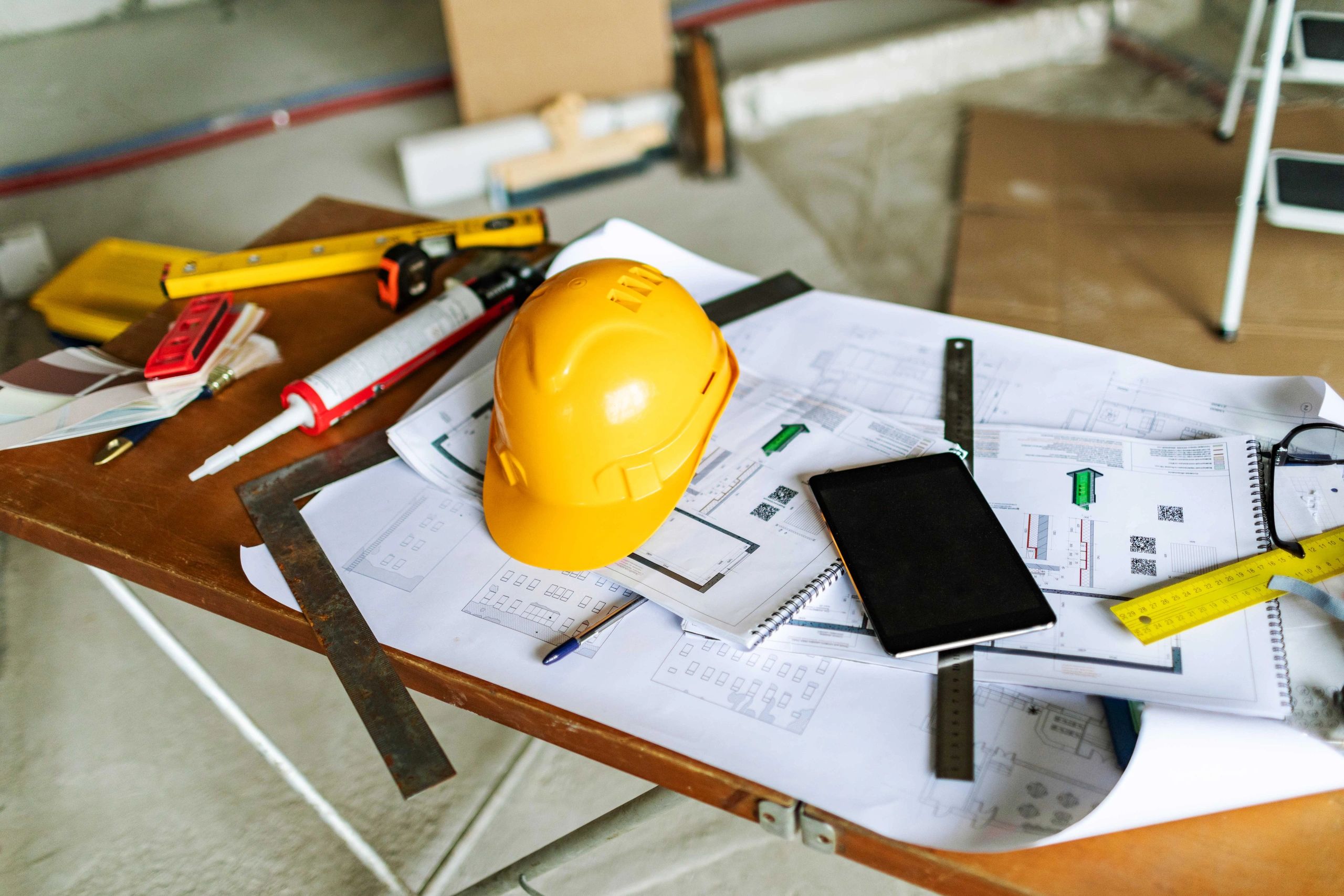 Construction plans with hard hat and tools